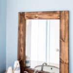 How to turn a thrift store mirror into a DIY Rustic Wood Mirror with this tutorial.