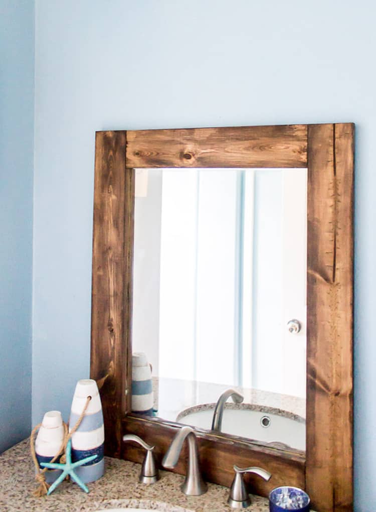 How to turn a thrift store mirror into a DIY Rustic Wood Mirror with this tutorial.