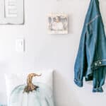 DIY Twine Pumpkin Sign hanging in a fall mudroom.